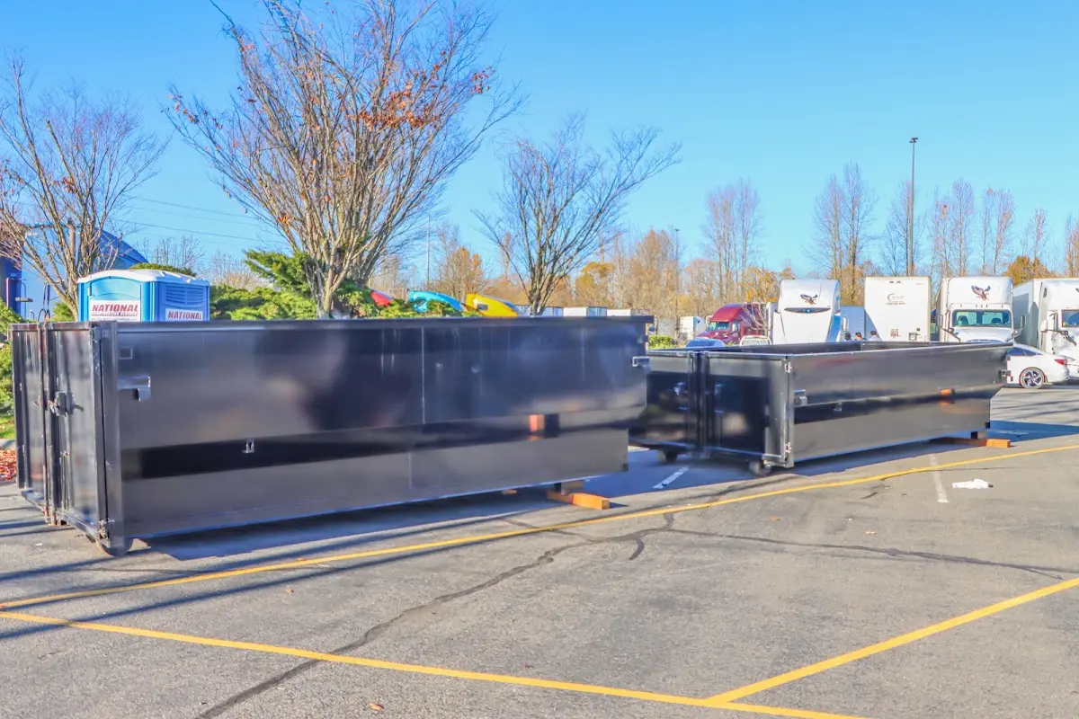 Professional dumpster rental service with roll-off container on residential driveway in Estes Park